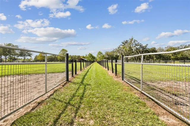 a bathroom with a granite countertop sink a mirror and vanity