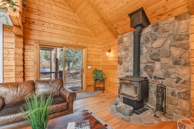 a living room with fireplace furniture and a floor to ceiling window