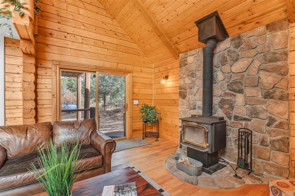 1350 Mitchell Mountain Road Westcliffe, CO 81252 - Photo 14 of 45 a living room with fireplace furniture and a floor to ceiling window