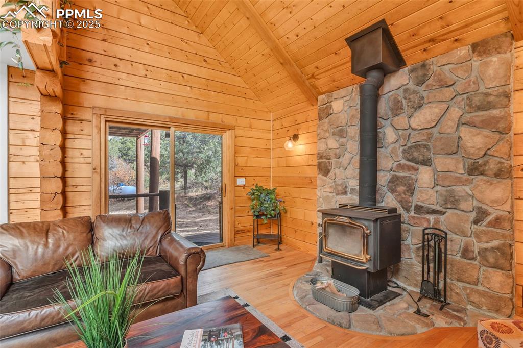 1350 Mitchell Mountain Road Westcliffe, CO 81252 - Photo 14 of 45 a living room with fireplace furniture and a floor to ceiling window