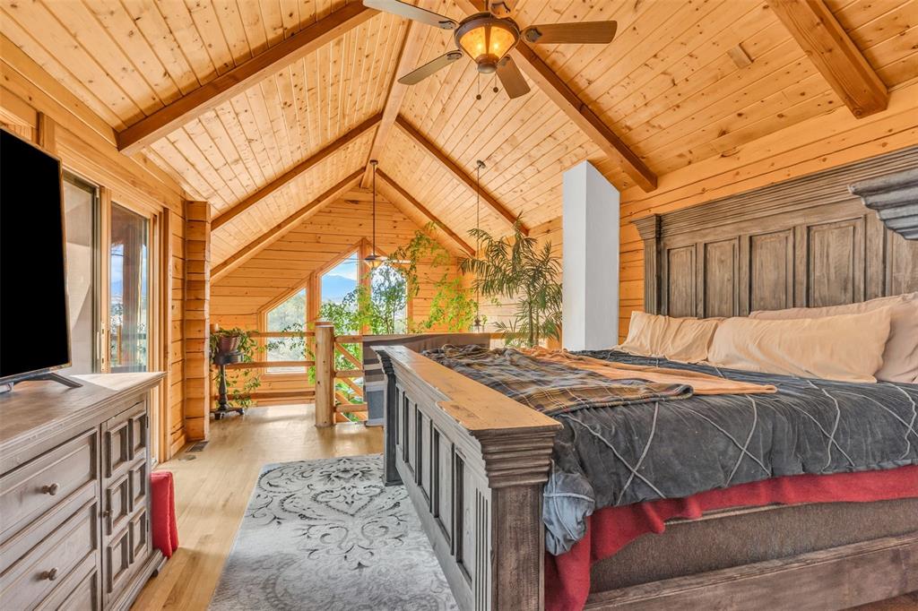 1350 Mitchell Mountain Road Westcliffe, CO 81252 - Photo 18 of 45 a bed sitting in a bedroom next to a window