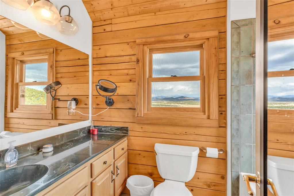 1350 Mitchell Mountain Road Westcliffe, CO 81252 - Photo 21 of 45 a bathroom with a sink and a large mirror
