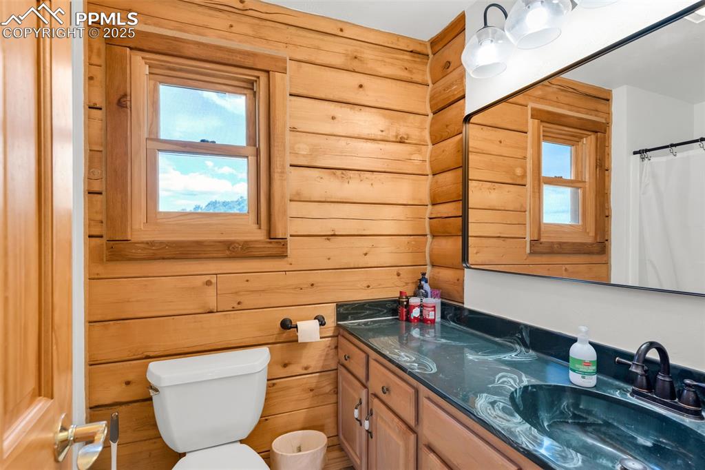 1350 Mitchell Mountain Road Westcliffe, CO 81252 - Photo 24 of 45 a bathroom with a granite countertop toilet sink and mirror