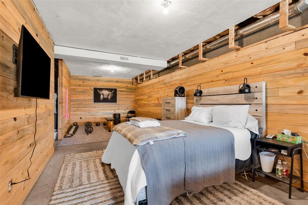 1350 Mitchell Mountain Road Westcliffe, CO 81252 - Photo 30 of 45 a spacious bedroom with a bed and a flat screen tv