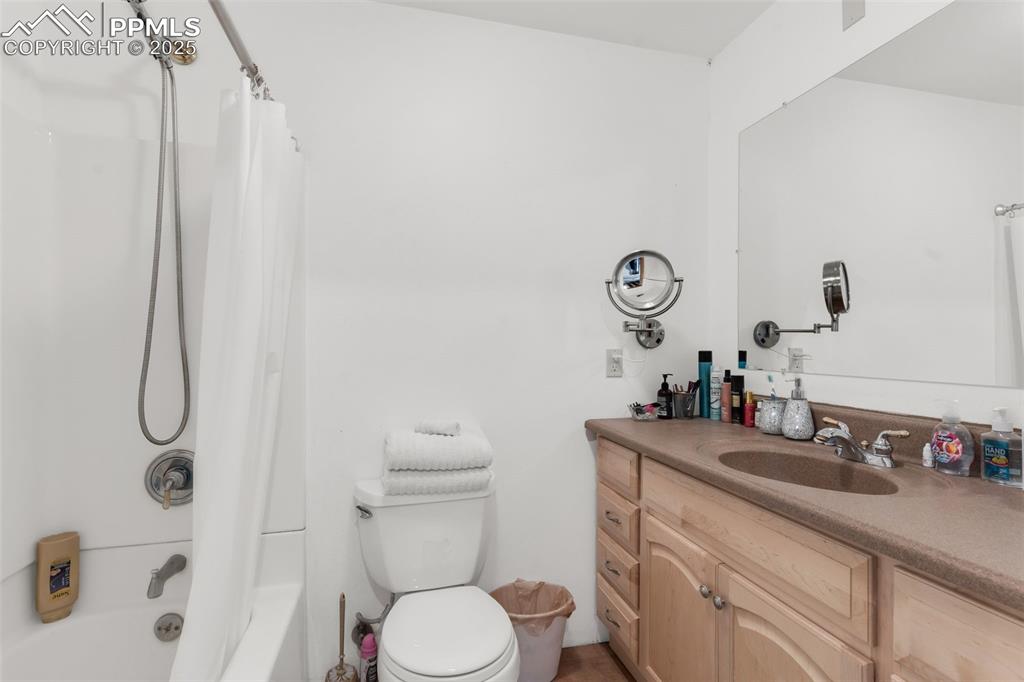 1350 Mitchell Mountain Road Westcliffe, CO 81252 - Photo 33 of 45 a bathroom with a sink a toilet and shower curtain
