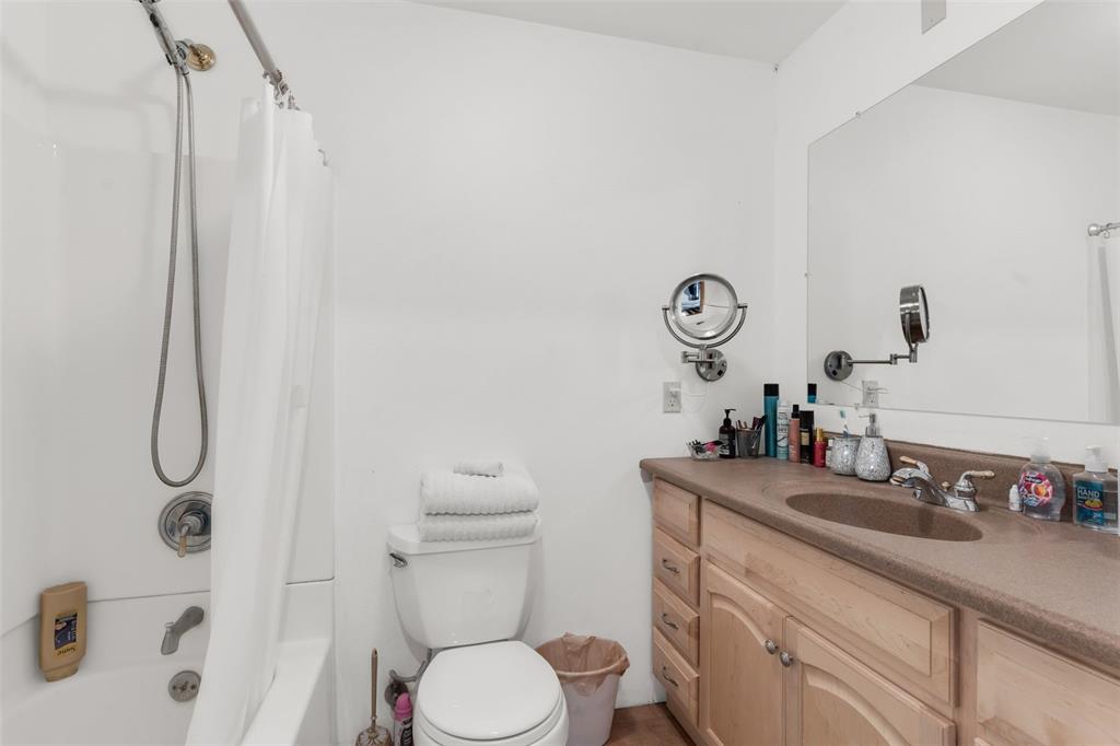 1350 Mitchell Mountain Road Westcliffe, CO 81252 - Photo 33 of 45 a bathroom with a sink a toilet and shower curtain