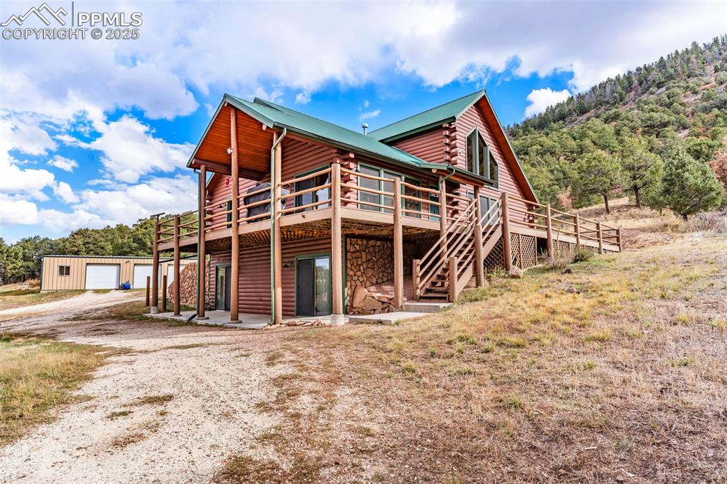 1350 Mitchell Mountain Road Westcliffe, CO 81252 - Photo 38 of 45 a view of a house with a big yard and large tree