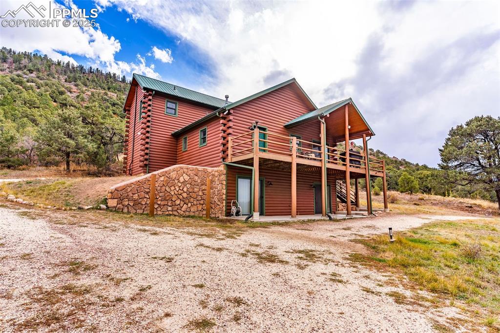 1350 Mitchell Mountain Road Westcliffe, CO 81252 - Photo 39 of 45 a view of a house with a yard covered in snow