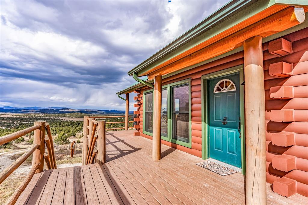 1350 Mitchell Mountain Road Westcliffe, CO 81252 - Photo 5 of 45 a view of balcony with chairs and wooden floor