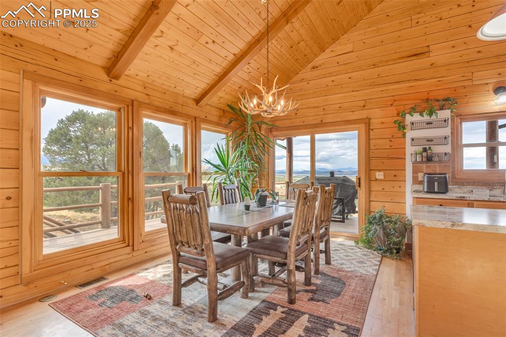 1350 Mitchell Mountain Road Westcliffe, CO 81252 - Photo 6 of 45 a view of a dining room with furniture wooden floor and a rug