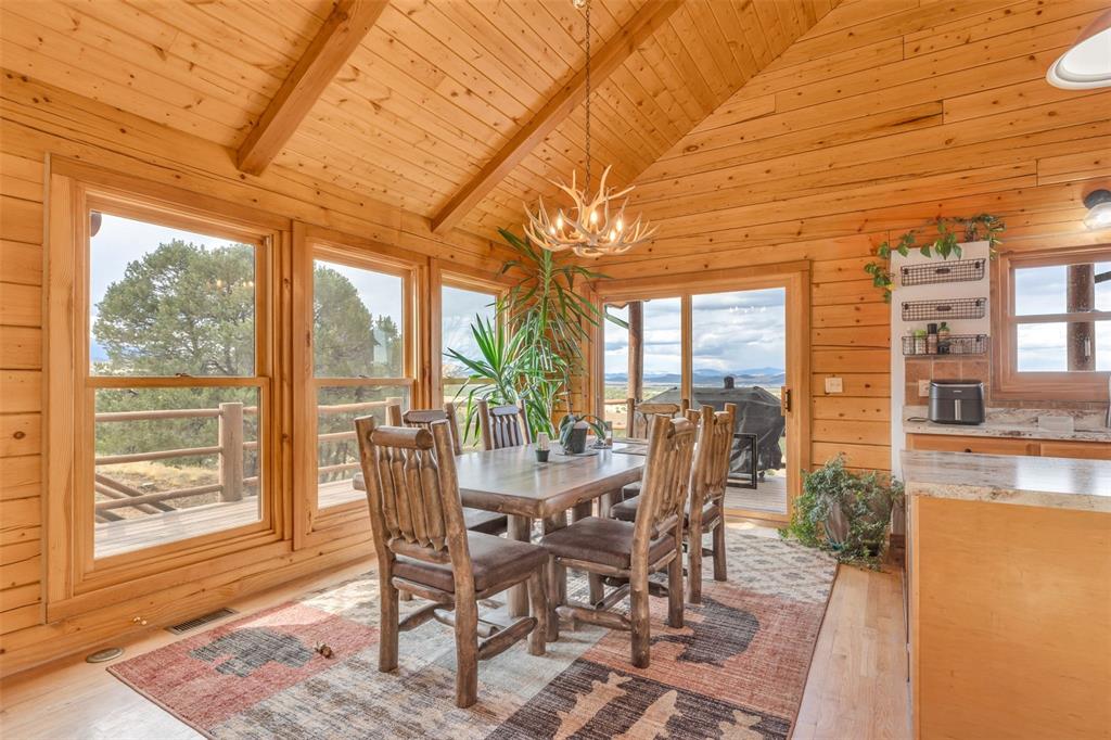 1350 Mitchell Mountain Road Westcliffe, CO 81252 - Photo 6 of 45 a view of a dining room with furniture wooden floor and a rug