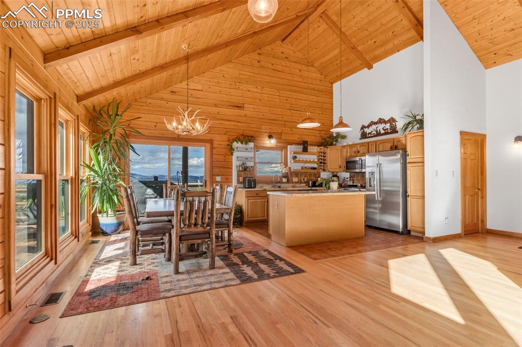 1350 Mitchell Mountain Road Westcliffe, CO 81252 - Photo 7 of 45 a view of a patio with dining table and chairs with wooden floor and fence