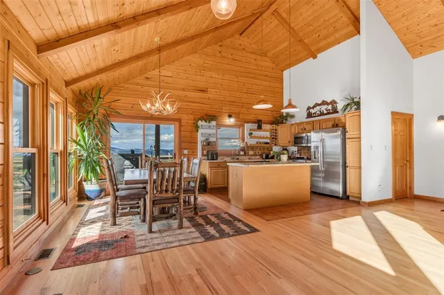 a view of a patio with a table and chairs and wooden floor