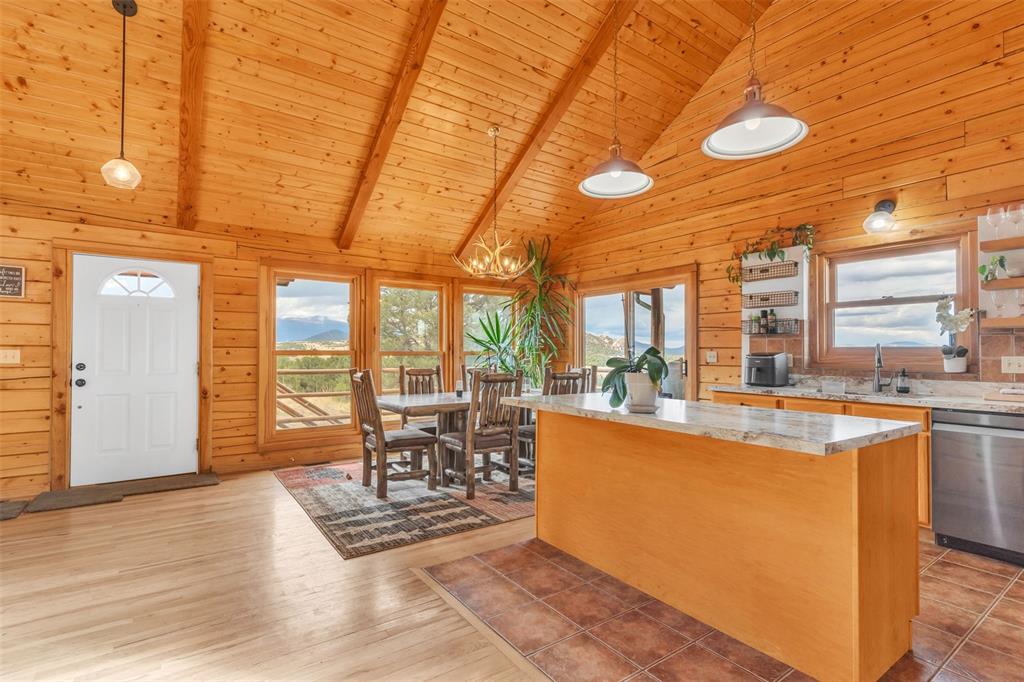1350 Mitchell Mountain Road Westcliffe, CO 81252 - Photo 9 of 45 a living room with furniture a large window with kitchen view