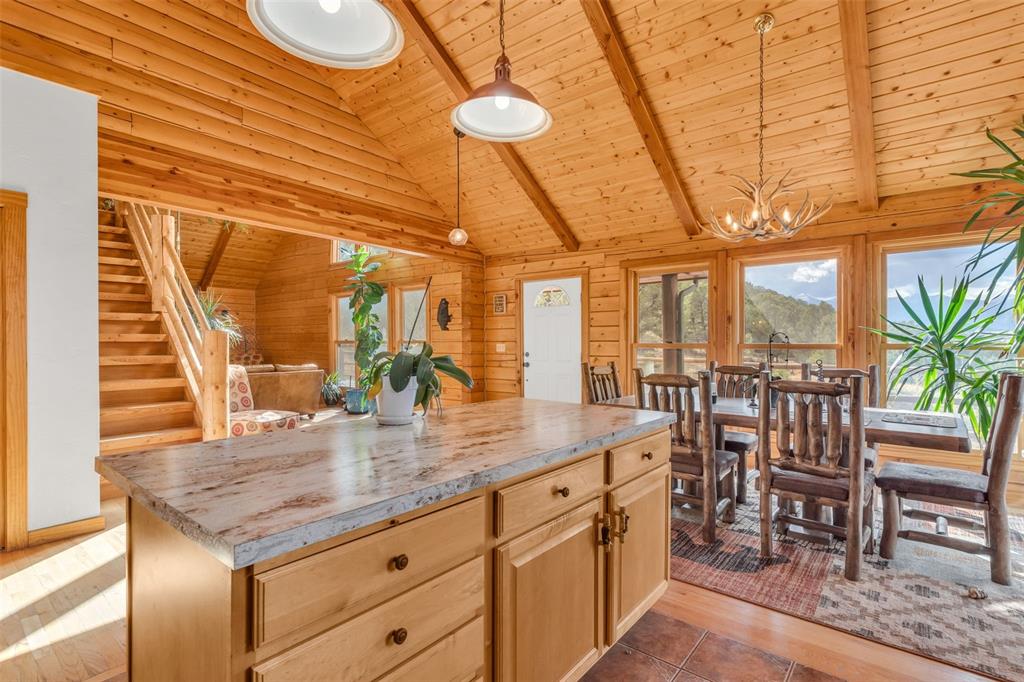 1350 Mitchell Mountain Road Westcliffe, CO 81252 - Photo 10 of 45 a kitchen with a table chairs and entryway