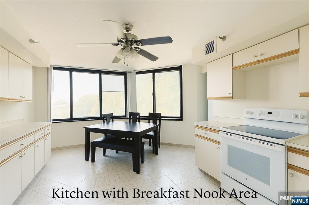 1265 15th Street, Unit 1A Fort Lee, NJ 07024 - Photo 8 of 14 a view of kitchen with sink microwave and refrigerator