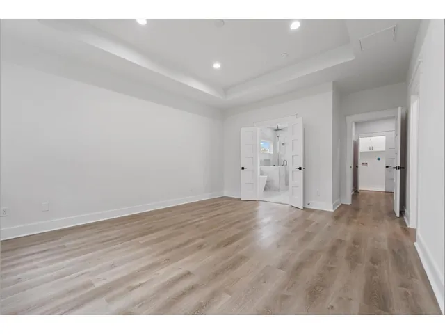 a bathroom with a tub shower sink and mirror