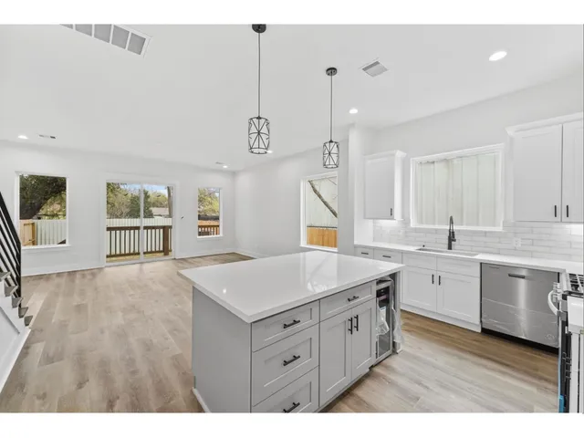 a kitchen with a sink a cabinets and window