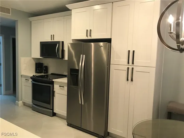 a kitchen with a table chairs stove and cabinets