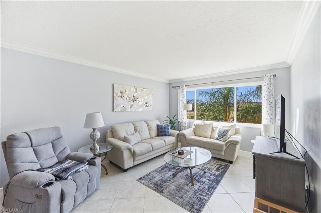 1010 Manatee Road, Unit B304 Naples, FL 34114 - Photo 1 of 24 a living room with furniture and a large window