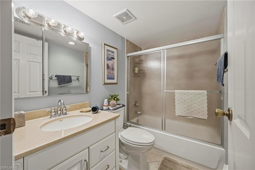 1010 Manatee Road, Unit B304 Naples, FL 34114 - Photo 12 of 24 a bathroom with a granite countertop sink toilet and shower