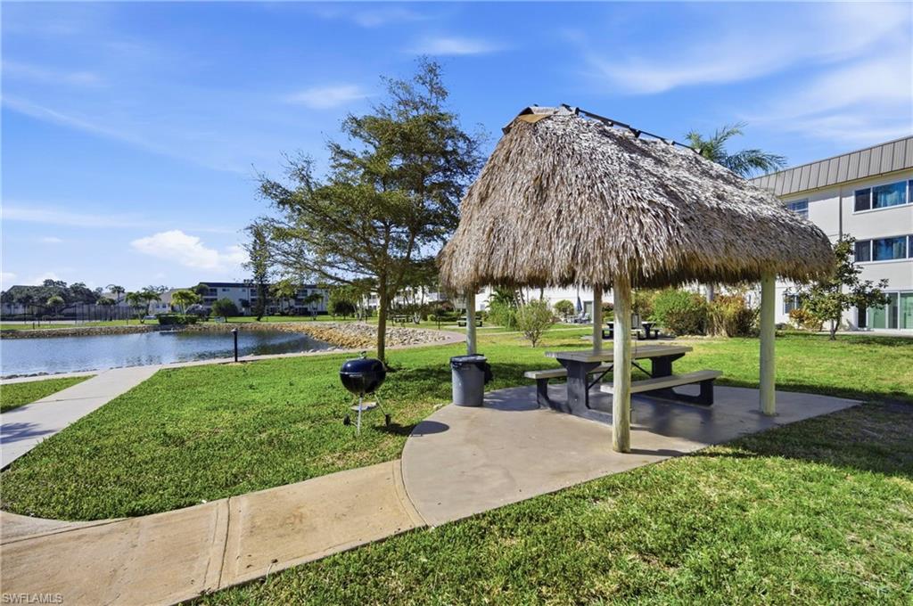 1010 Manatee Road, Unit B304 Naples, FL 34114 - Photo 17 of 24 a view of a garden with a bench and lawn chairs