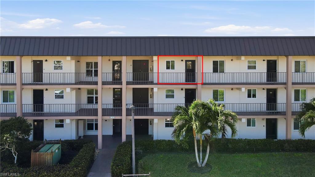 1010 Manatee Road, Unit B304 Naples, FL 34114 - Photo 20 of 24 a front view of a building with a yard
