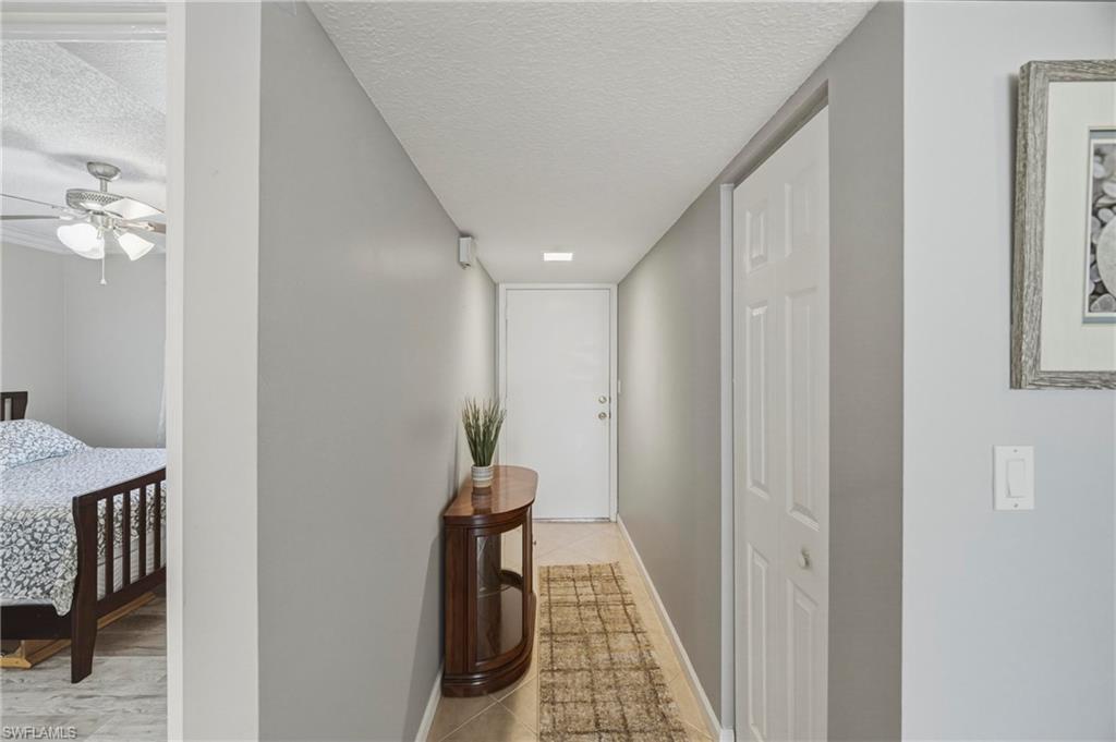 1010 Manatee Road, Unit B304 Naples, FL 34114 - Photo 23 of 24 a view of a hallway with wooden floor and staircase