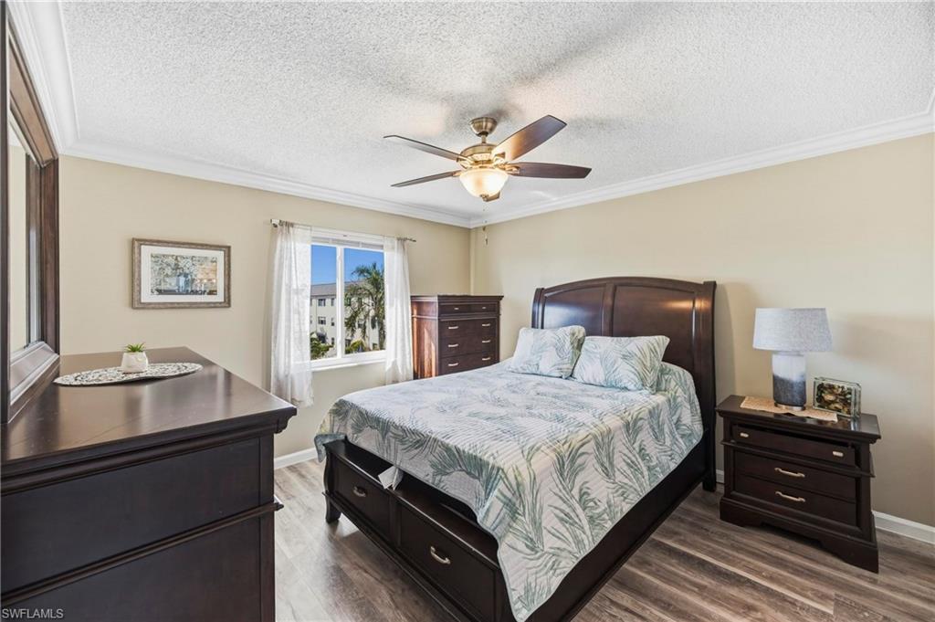 1010 Manatee Road, Unit B304 Naples, FL 34114 - Photo 3 of 24 a bedroom with a bed and wooden floor