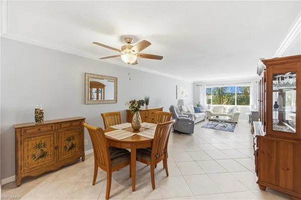 a dining room with furniture a window and a chandelier