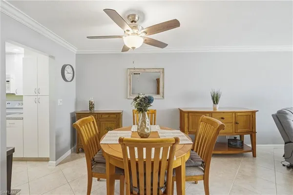a view of a dining room with furniture and a chandelier