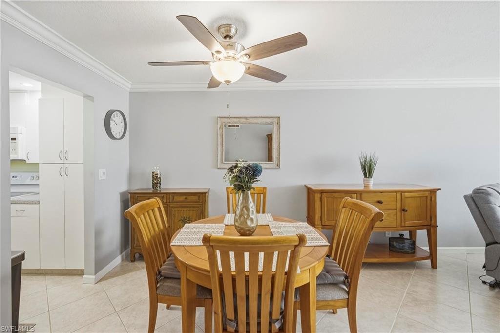 1010 Manatee Road, Unit B304 Naples, FL 34114 - Photo 8 of 24 a view of a dining room with furniture and a chandelier