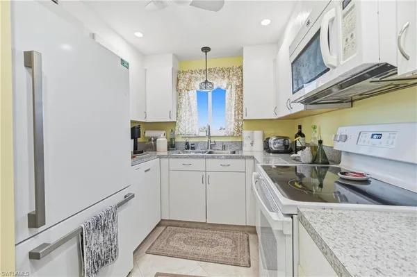 a kitchen with a sink cabinets and window