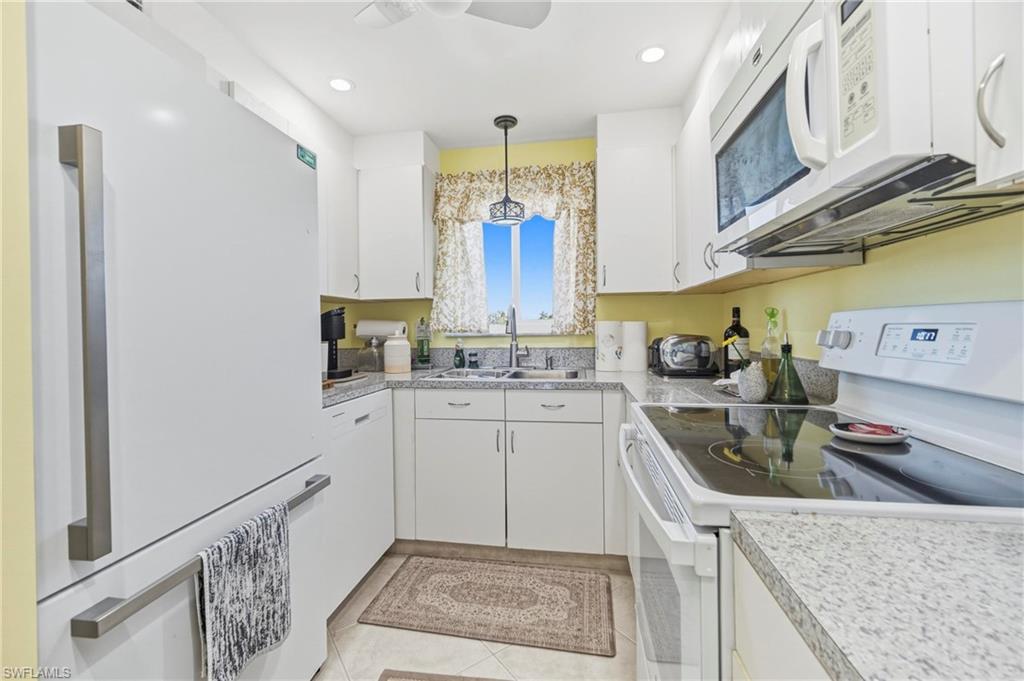 1010 Manatee Road, Unit B304 Naples, FL 34114 - Photo 10 of 24 a kitchen with a sink cabinets and window