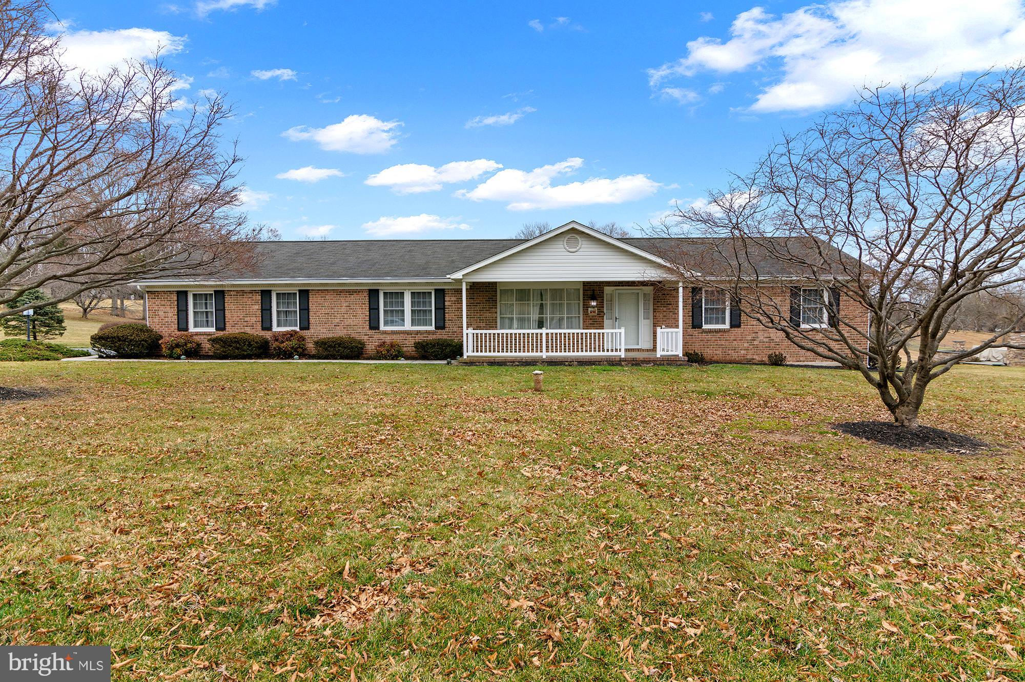 Charming brick home with inviting porch.