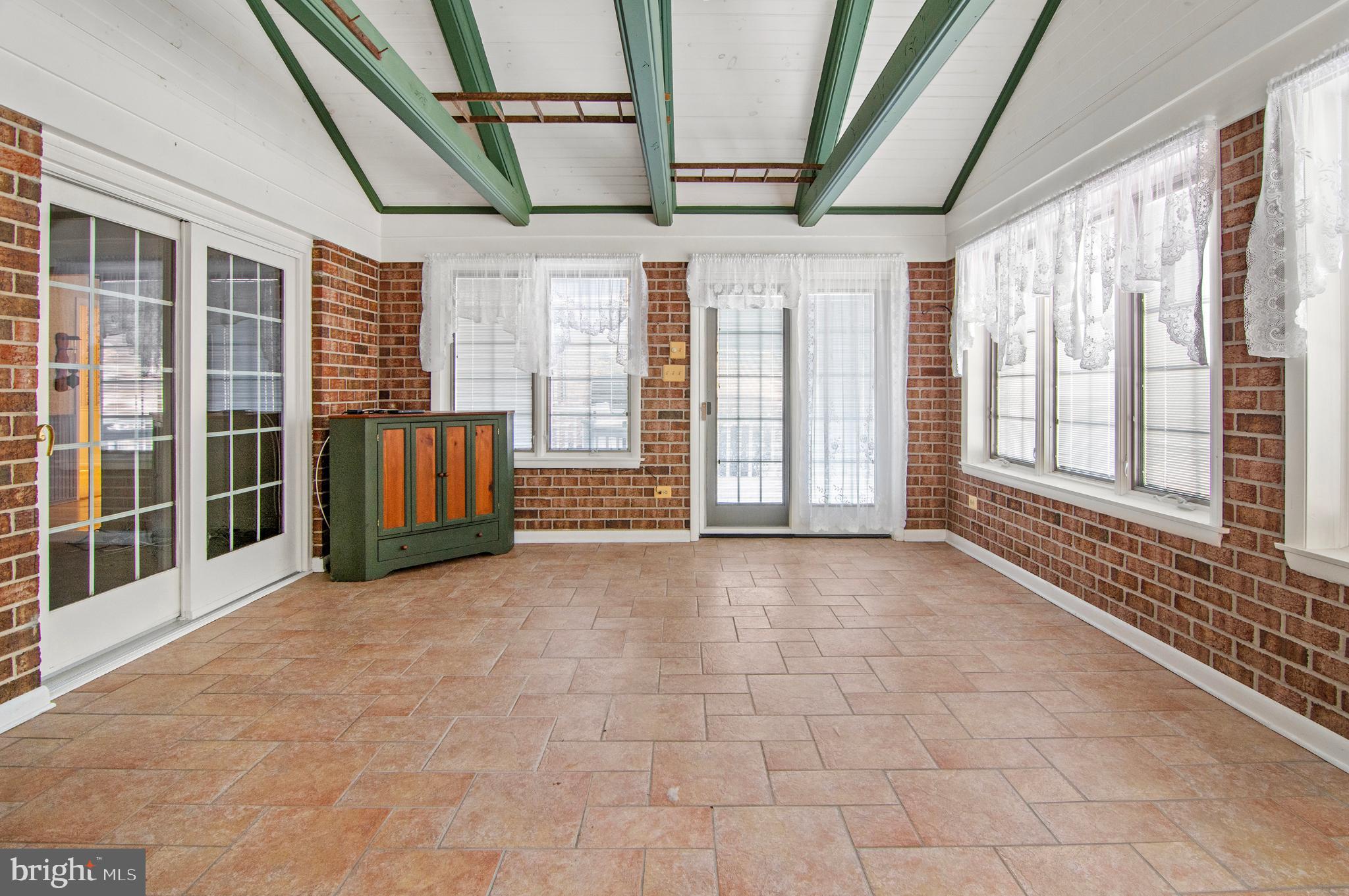 3005 Moores Road Baldwin, MD 21013 - Photo 44 of 56 Bright sunroom with charming brick accents.
