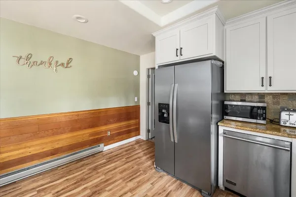 a kitchen with stainless steel appliances granite countertop a refrigerator and a stove top oven