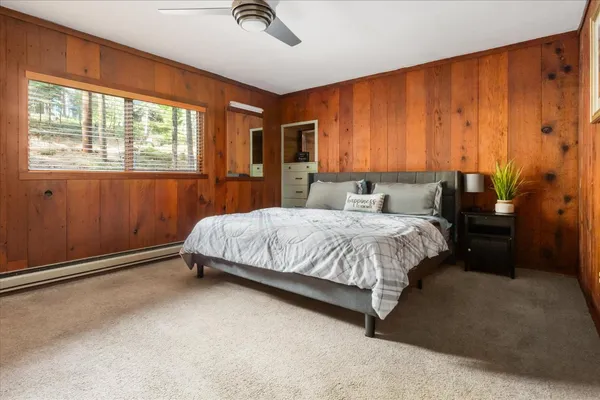 a bedroom with a bed lamp and a window
