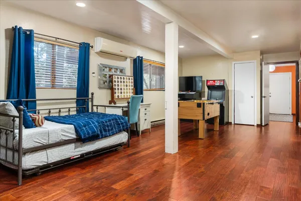 a bedroom with furniture and a wooden floor
