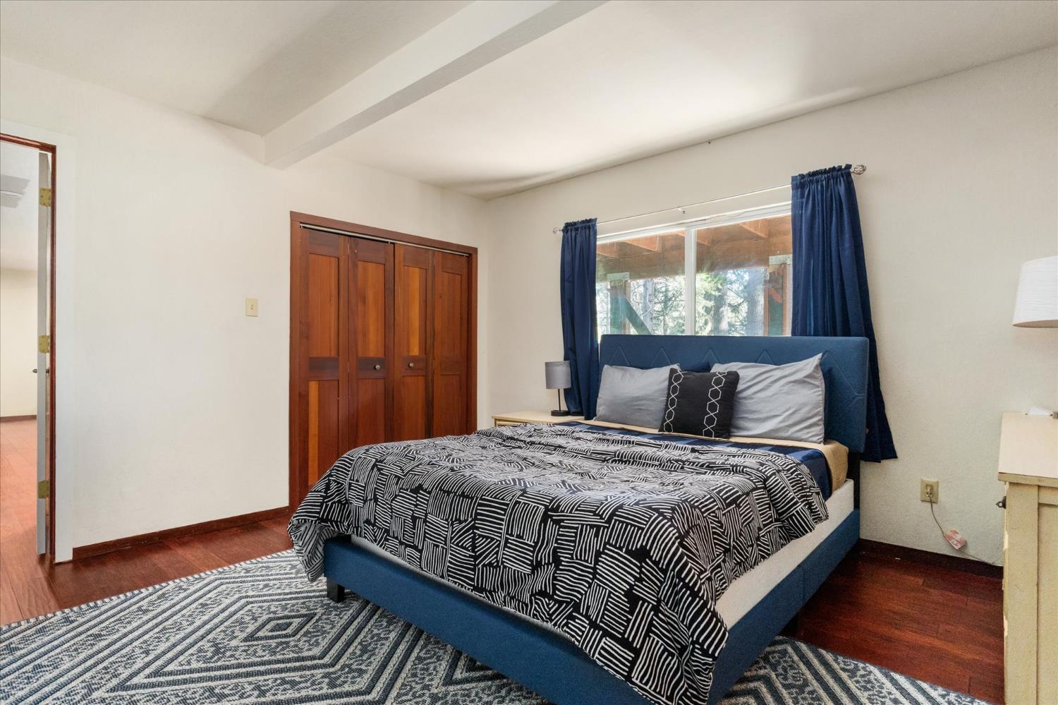 485 Moran Road Arnold, CA 95223 - Photo 28 of 49 a bedroom with a bed and wooden floor