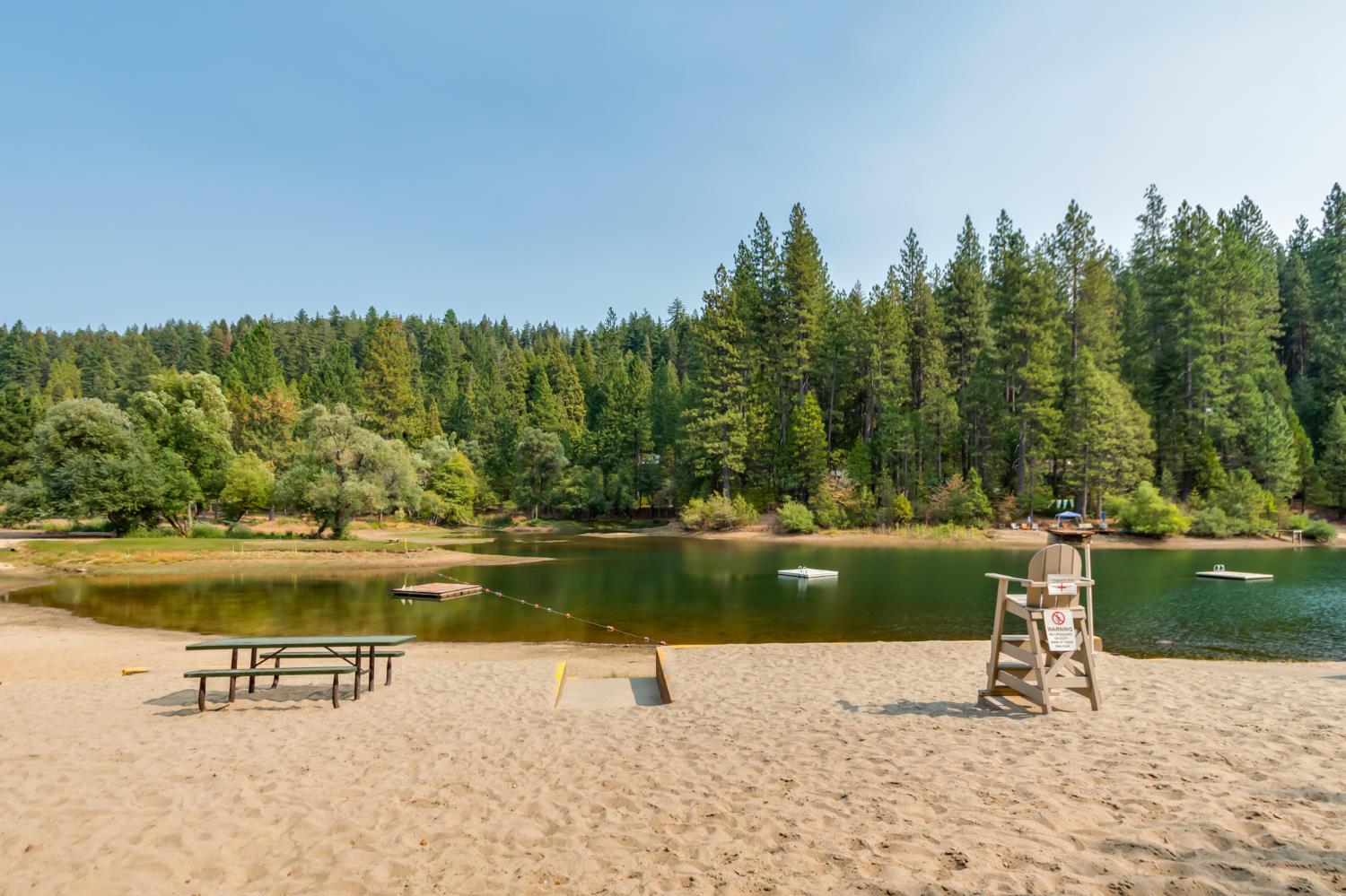 485 Moran Road Arnold, CA 95223 - Photo 46 of 49 a view of a lake with a bench in front of lake