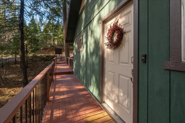 a view of balcony with wooden floor and fence