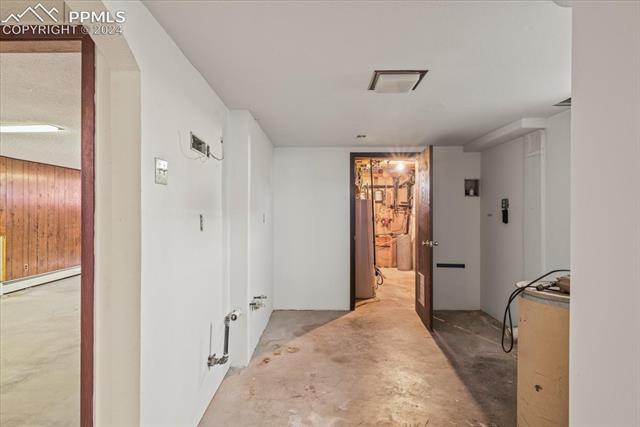 28018 County Farm Road Pueblo, CO 81006 - Photo 27 of 50 Hall featuring concrete floors, a baseboard heating unit, gas water heater, and a textured ceiling