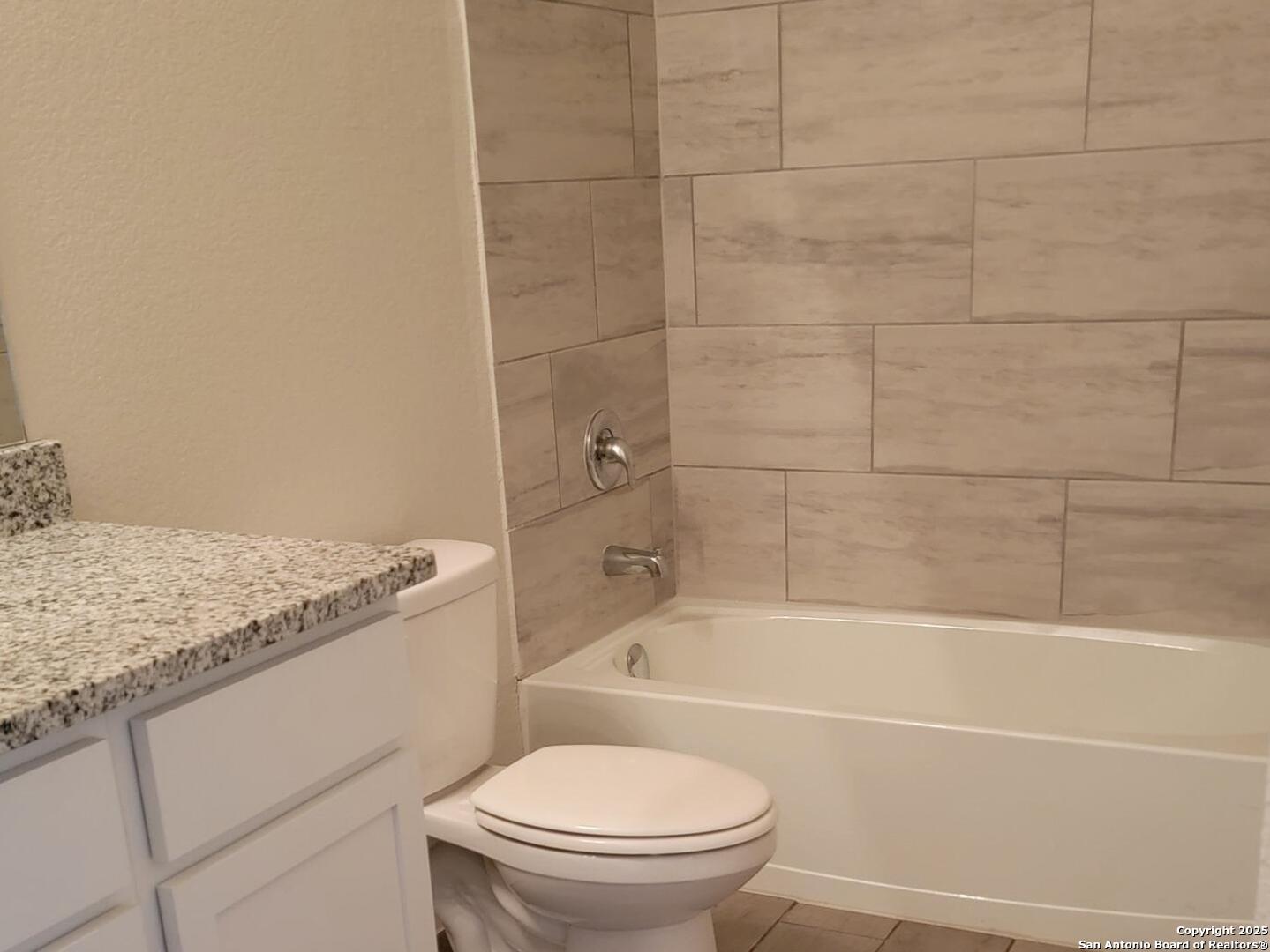 609 Steele Shallows Cibolo, TX 78108 - Photo 27 of 37 a bathroom with a granite countertop toilet sink and bathtub