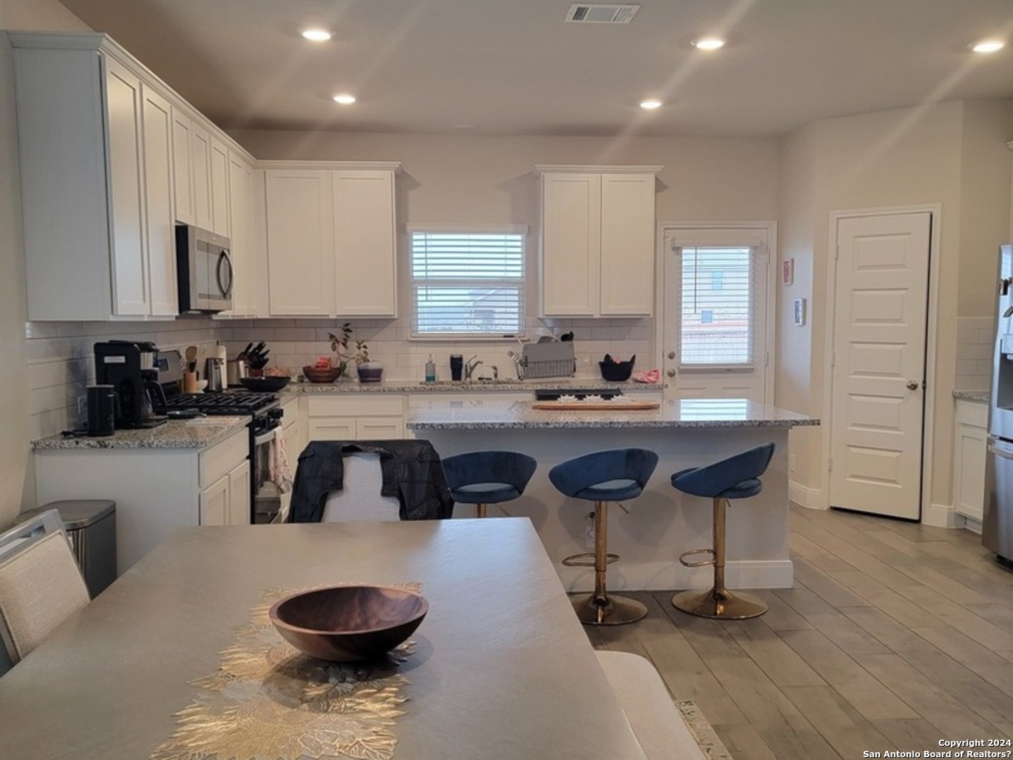 609 Steele Shallows Cibolo, TX 78108 - Photo 6 of 37 a kitchen with a sink a stove a refrigerator and cabinets
