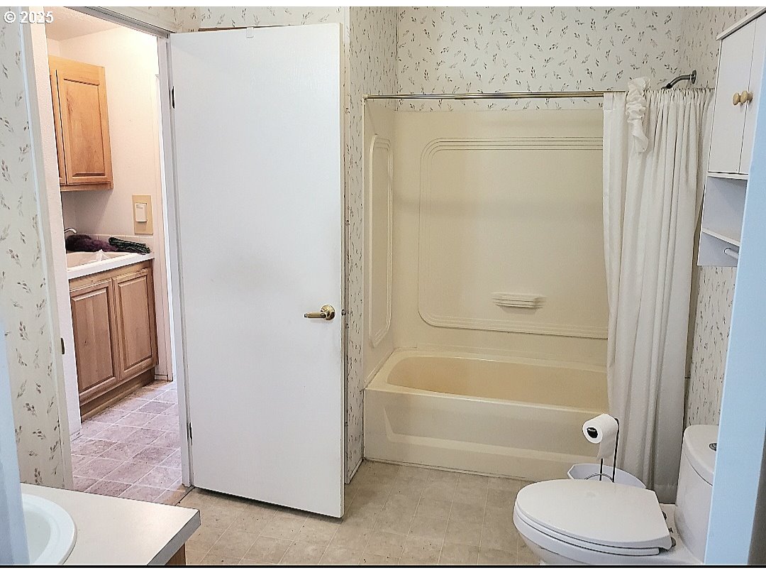 1125 58th Street, Unit 6 Springfield, OR 97478 - Photo 13 of 27 a bathroom with a granite countertop bathtub shower and toilet