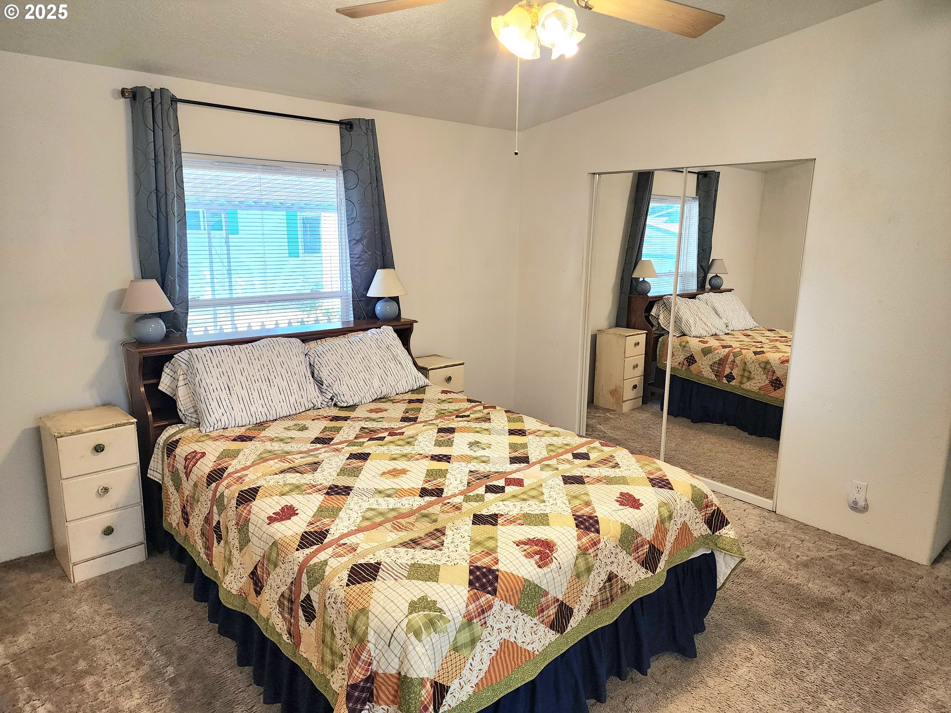 1125 58th Street, Unit 6 Springfield, OR 97478 - Photo 14 of 27 a bedroom with a bed and a chandelier