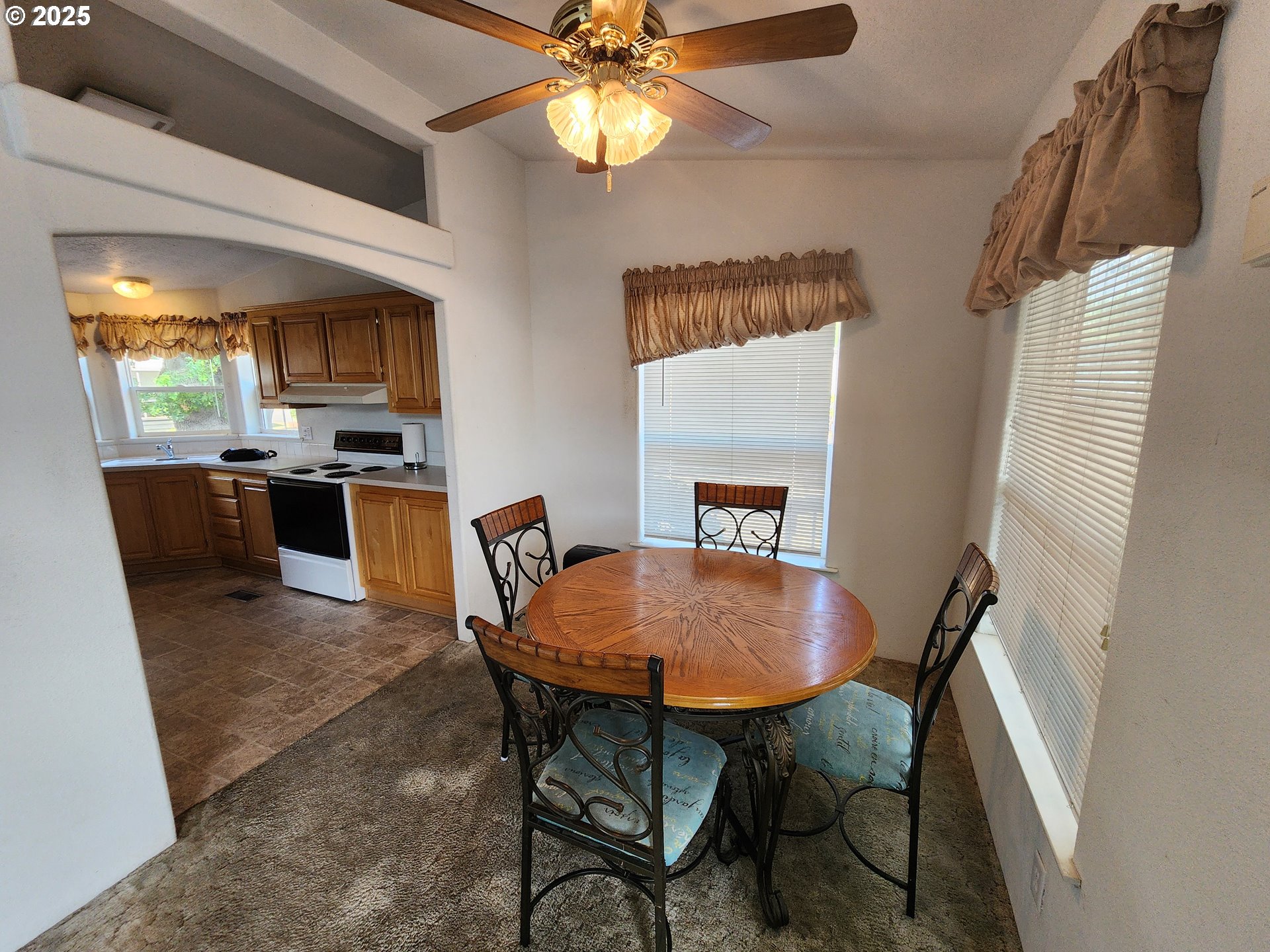 1125 58th Street, Unit 6 Springfield, OR 97478 - Photo 10 of 27 a view of a dining room with furniture window and wooden floor
