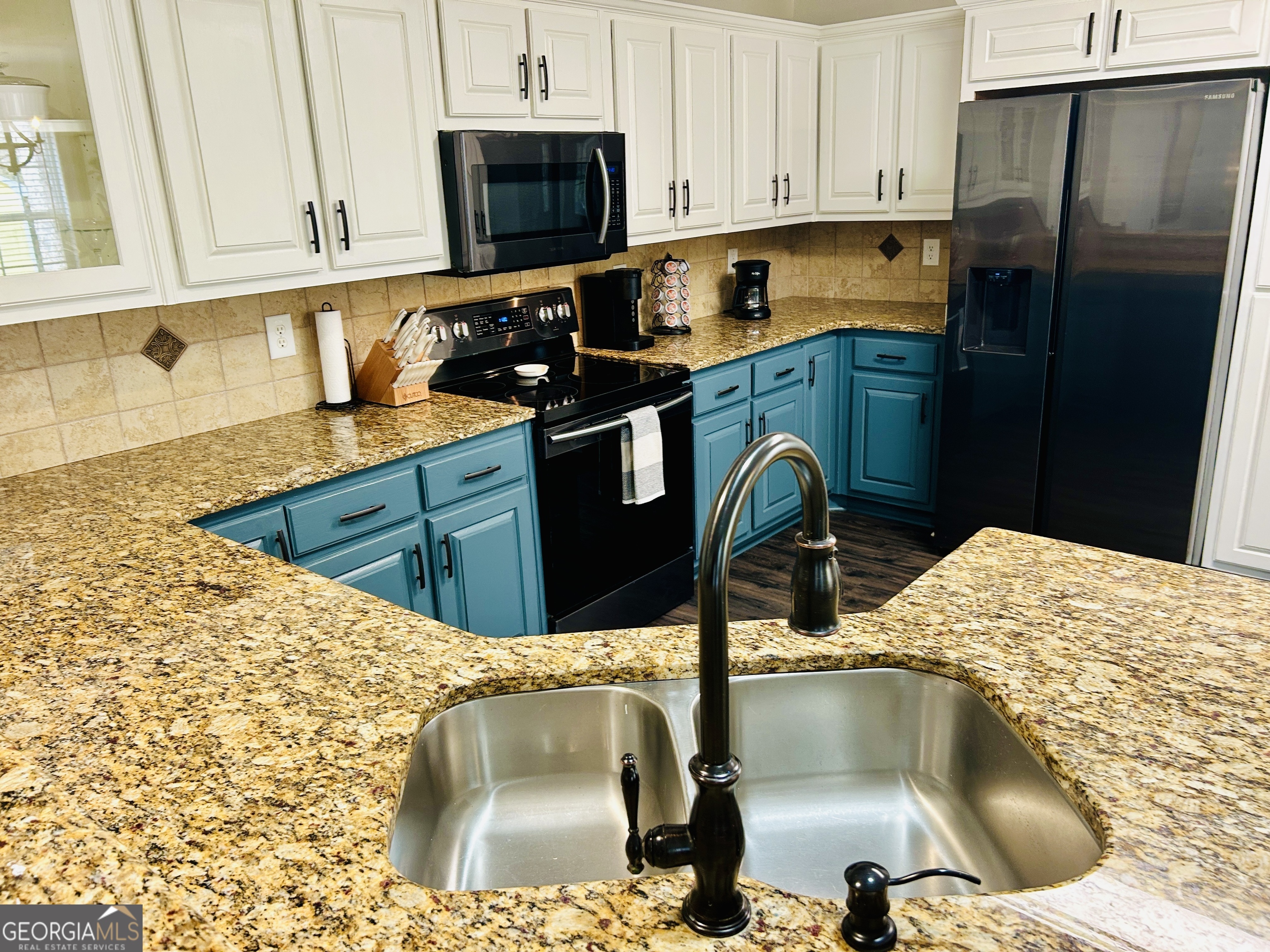 129 Rockwind Way Demorest, GA 30535 - Photo 15 of 45 a kitchen with stainless steel appliances kitchen island wooden cabinets a sink and a stove