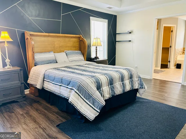 a bedroom with a bed and a dresser